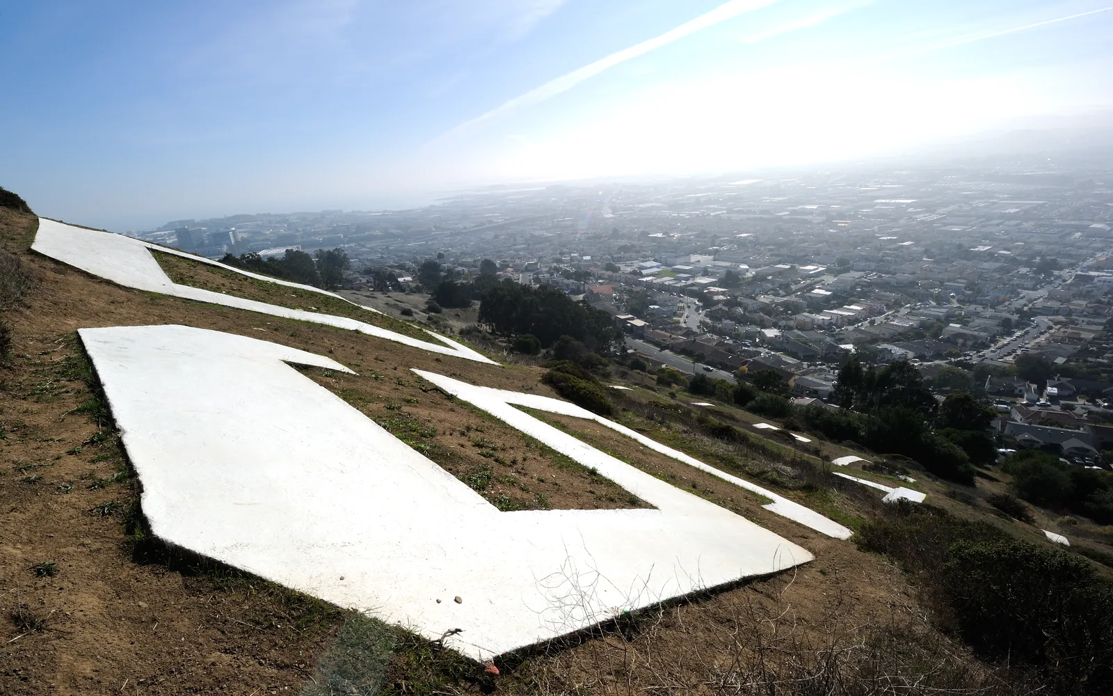 The South San Francisco 'The Industrial City' sign on a hillside in South San Francisco, with large white letters visible against the landscape